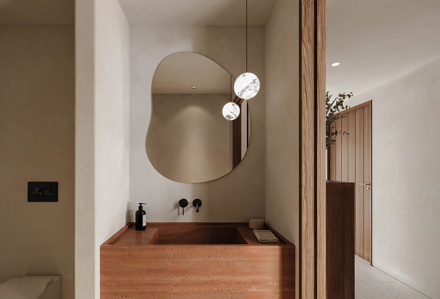 Bathrooms are kept quiet and discreet, following the same material and structural vocabulary as the main spaces