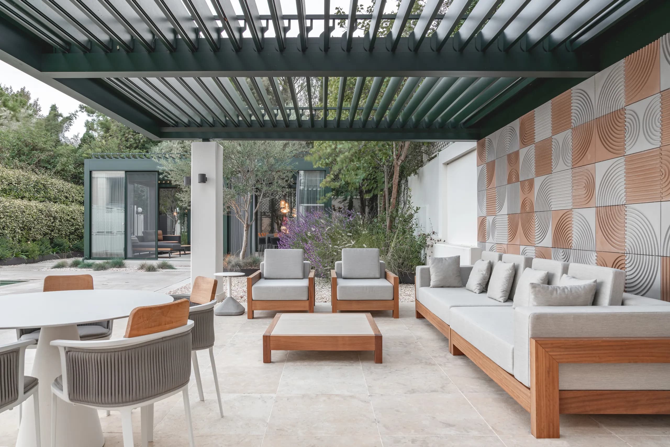 The open-air living room beneath its pergola