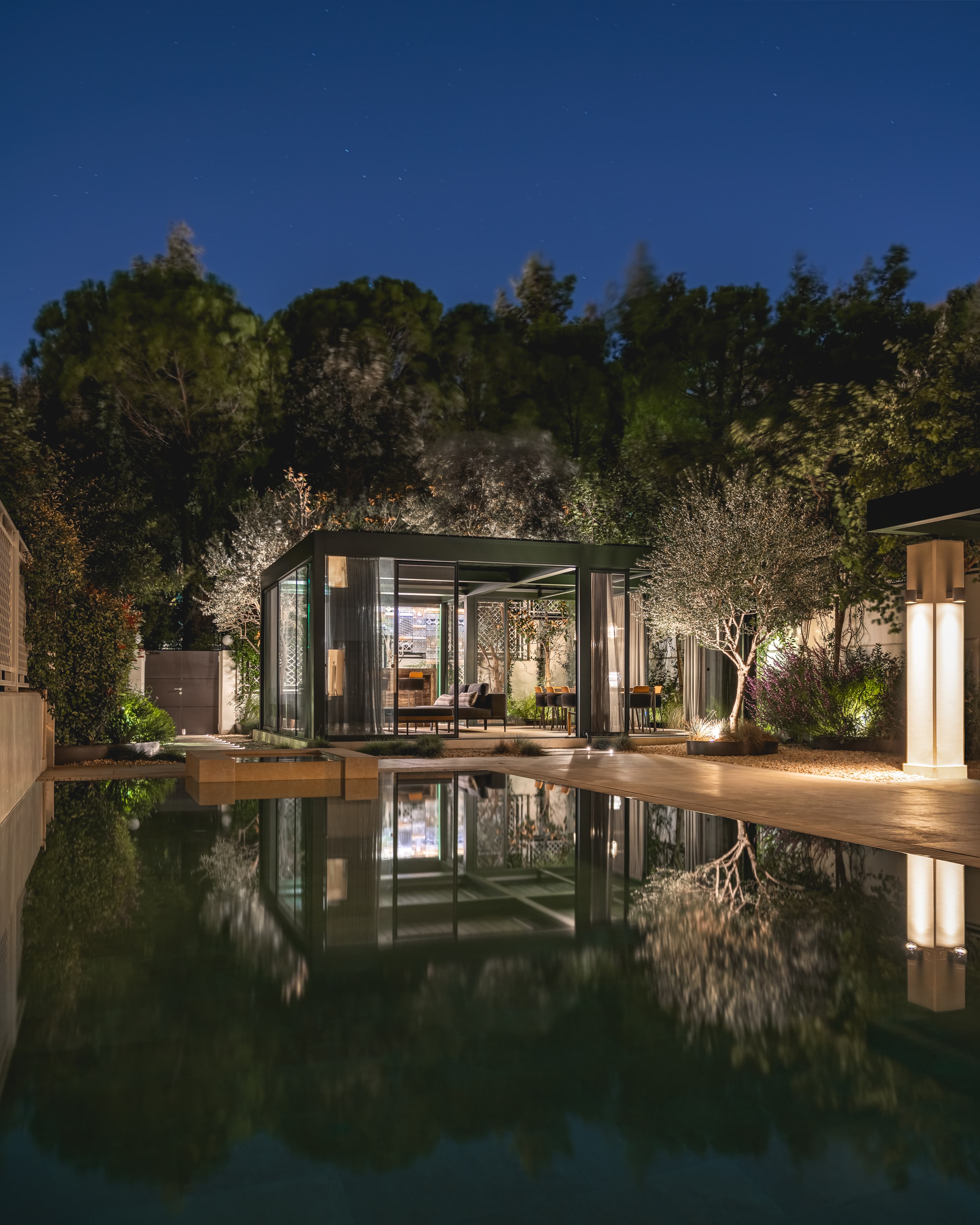 The pavilion glowing above the swimming pool
