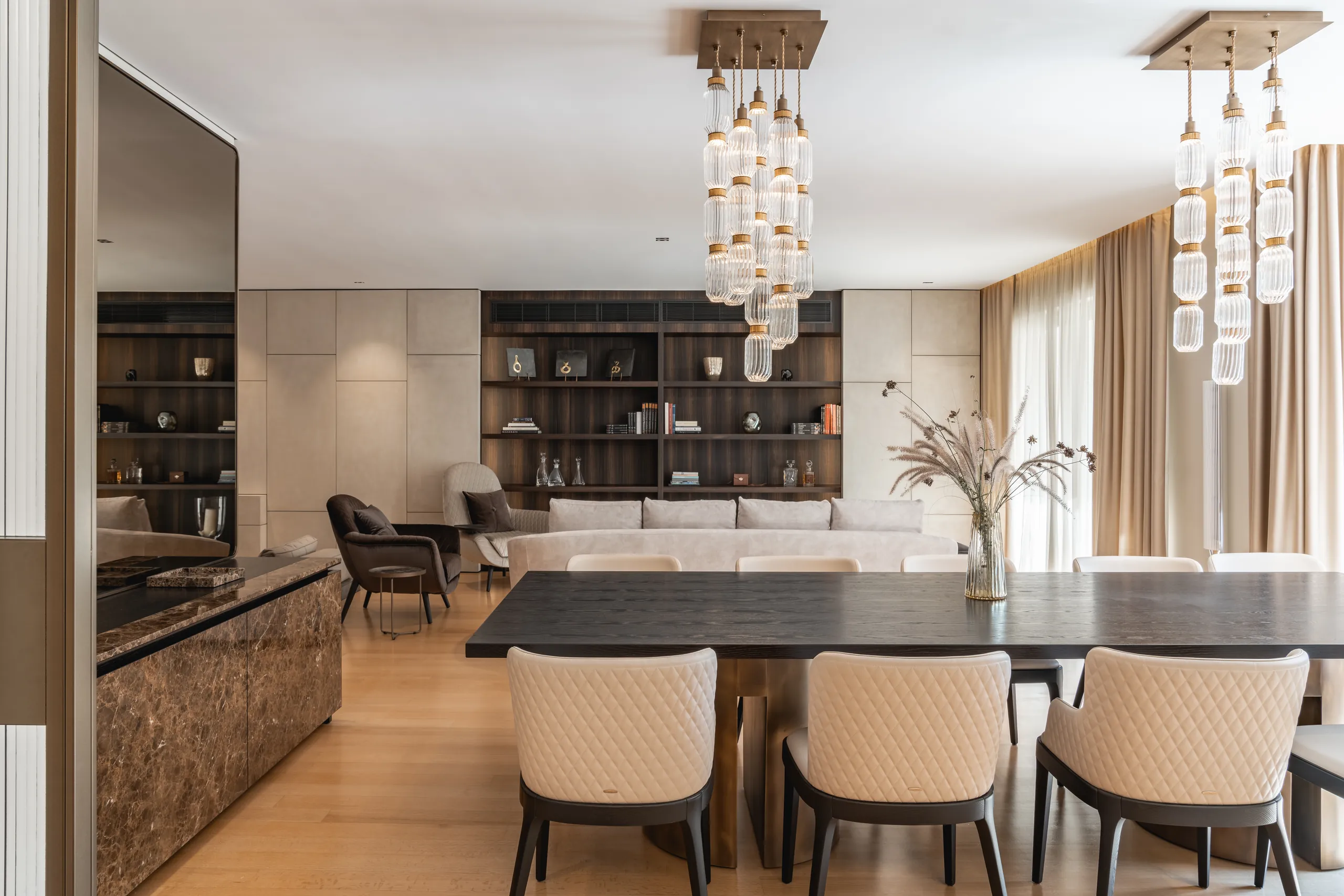 Dining space under cascading glass chandeliers