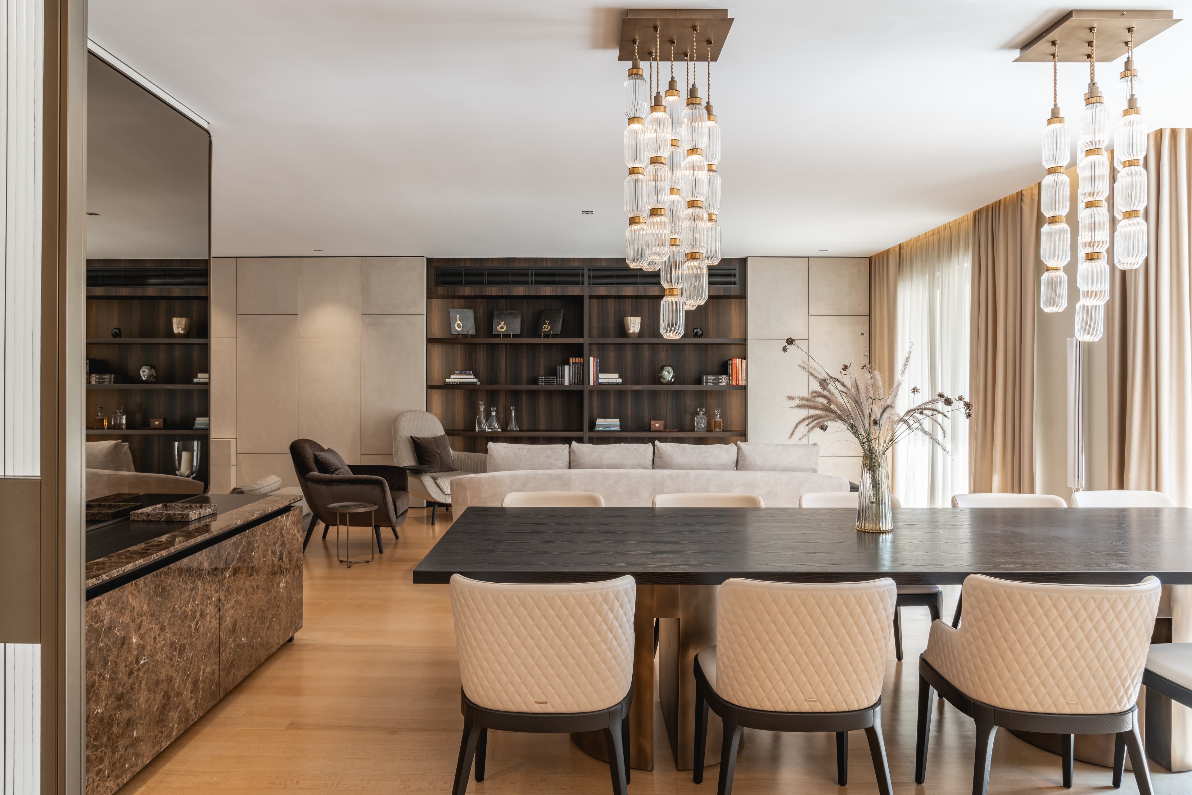 Dining space under cascading glass chandeliers