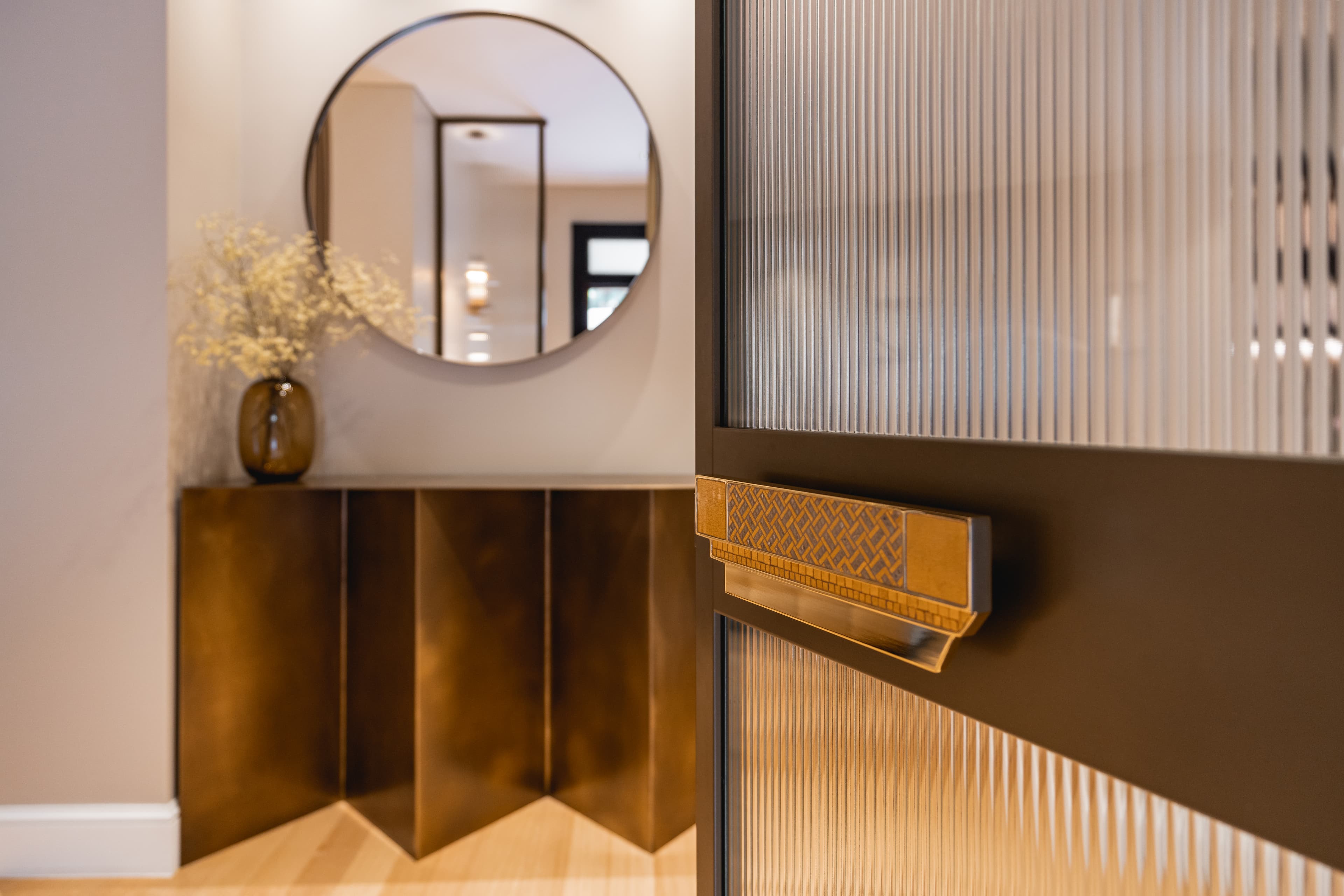 Entrance hall with folded brass console and mirror