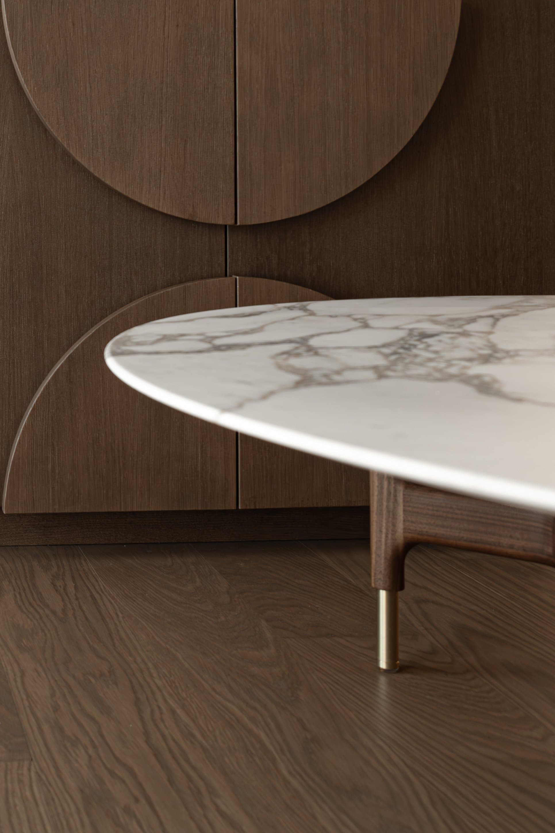 Marble coffee table against half-circle cabinetry motifs