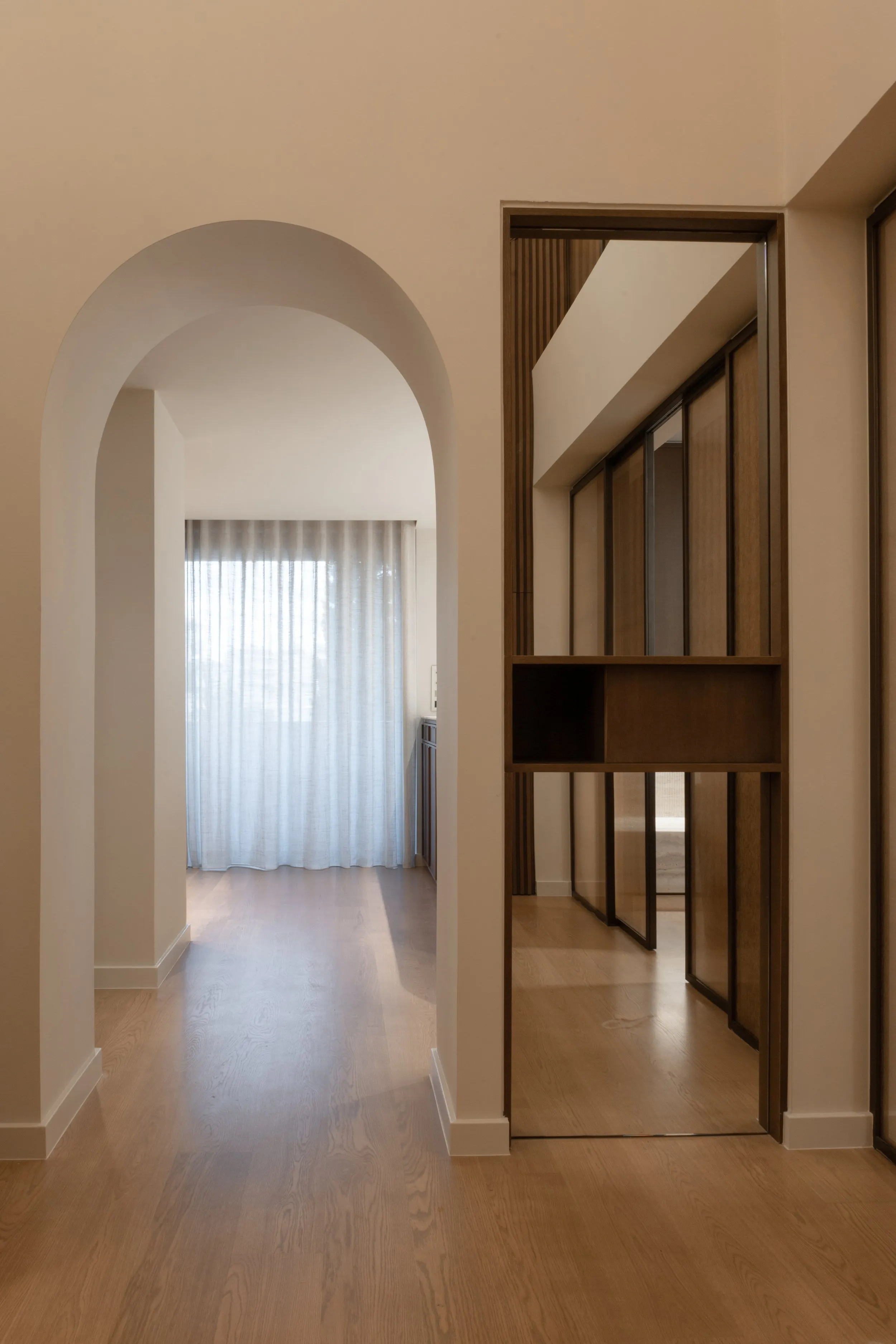 Arched hallway and sliding glass partition