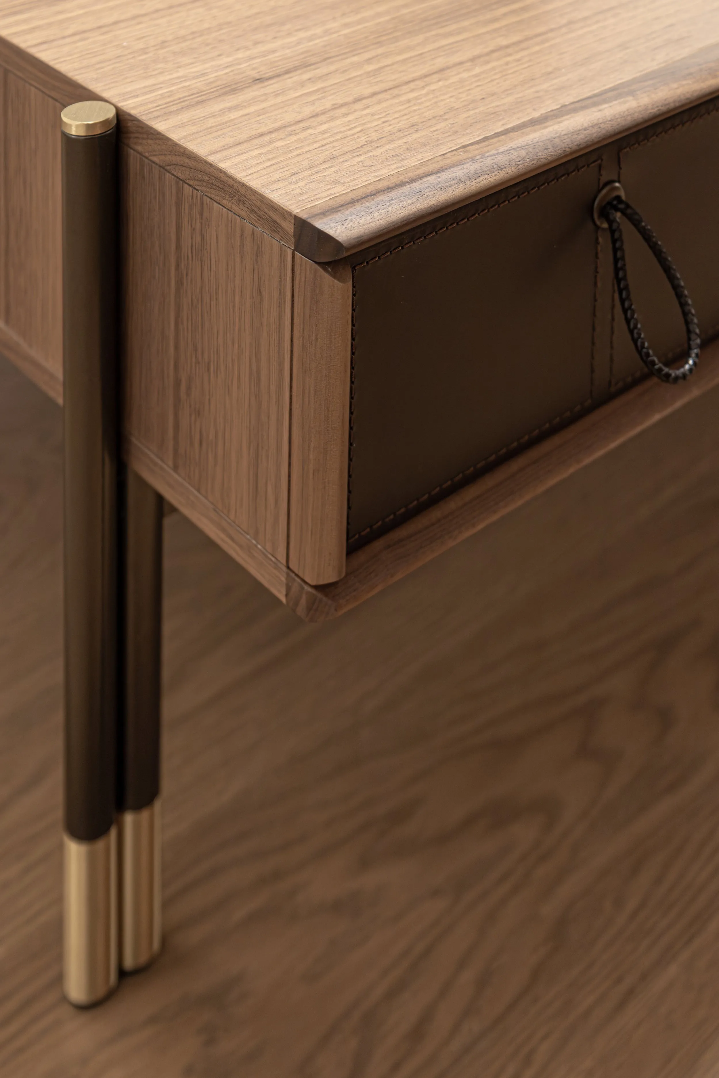 Walnut nightstand with leather pull and brass-tipped legs