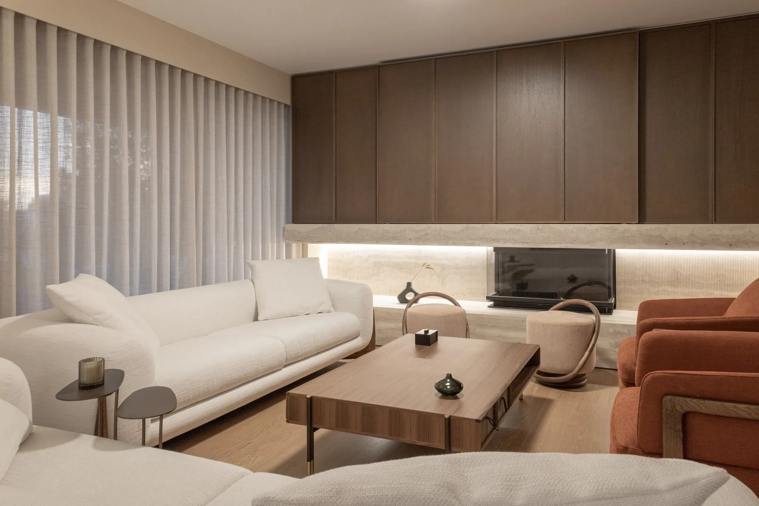 Living area with sheer curtains and walnut paneling
