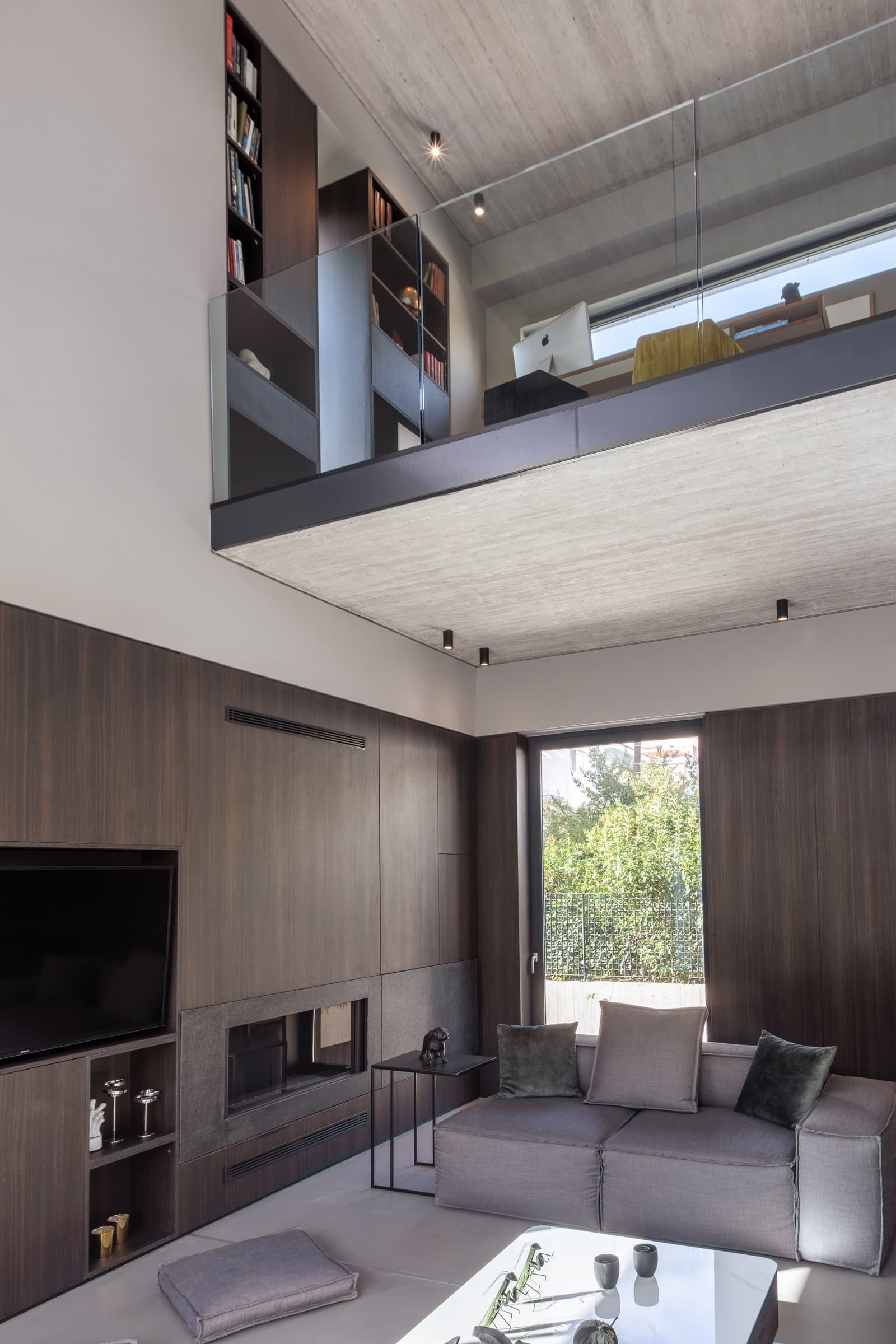 Double-height living area beneath the mezzanine office