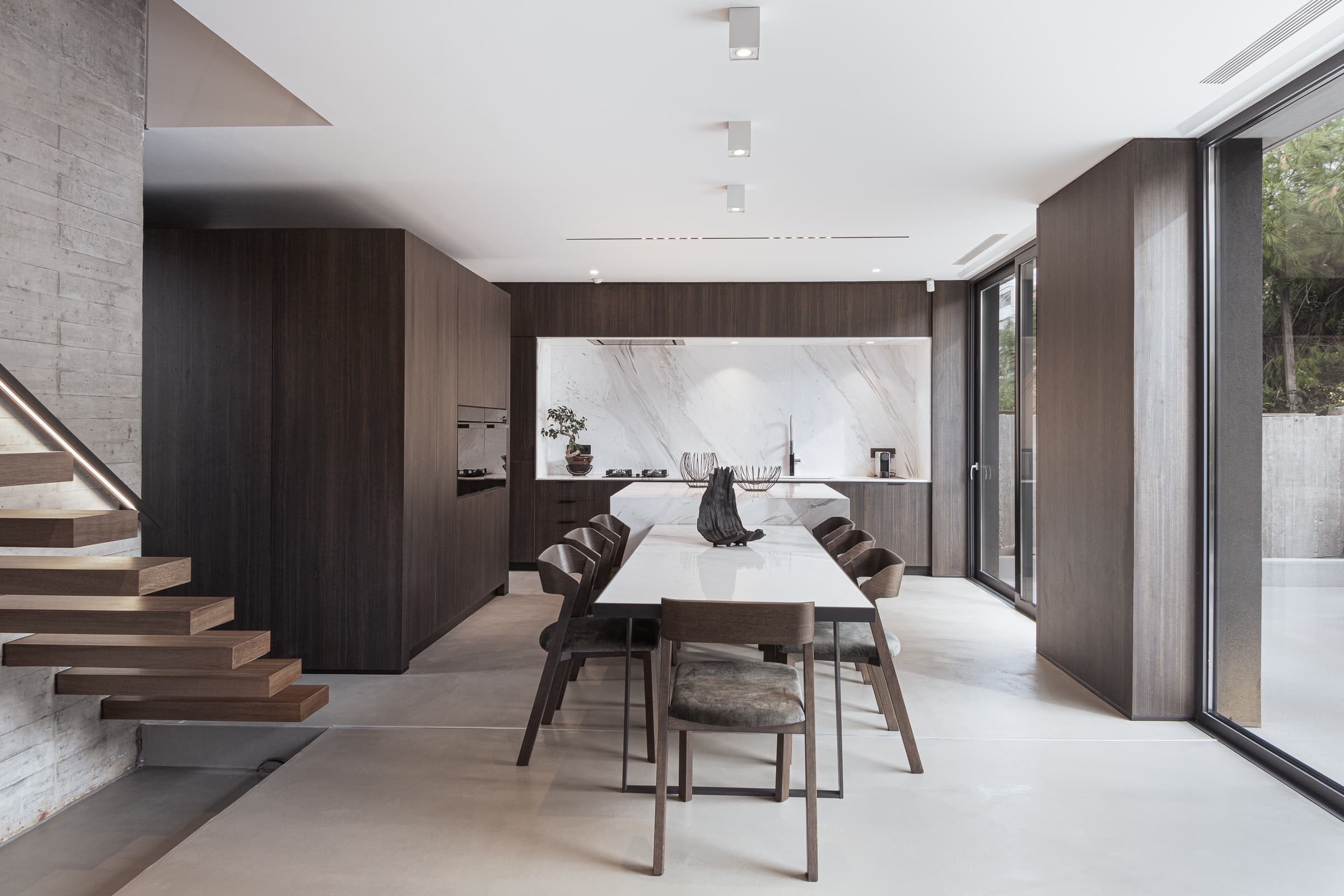 Dining area at the foot of the floating staircase