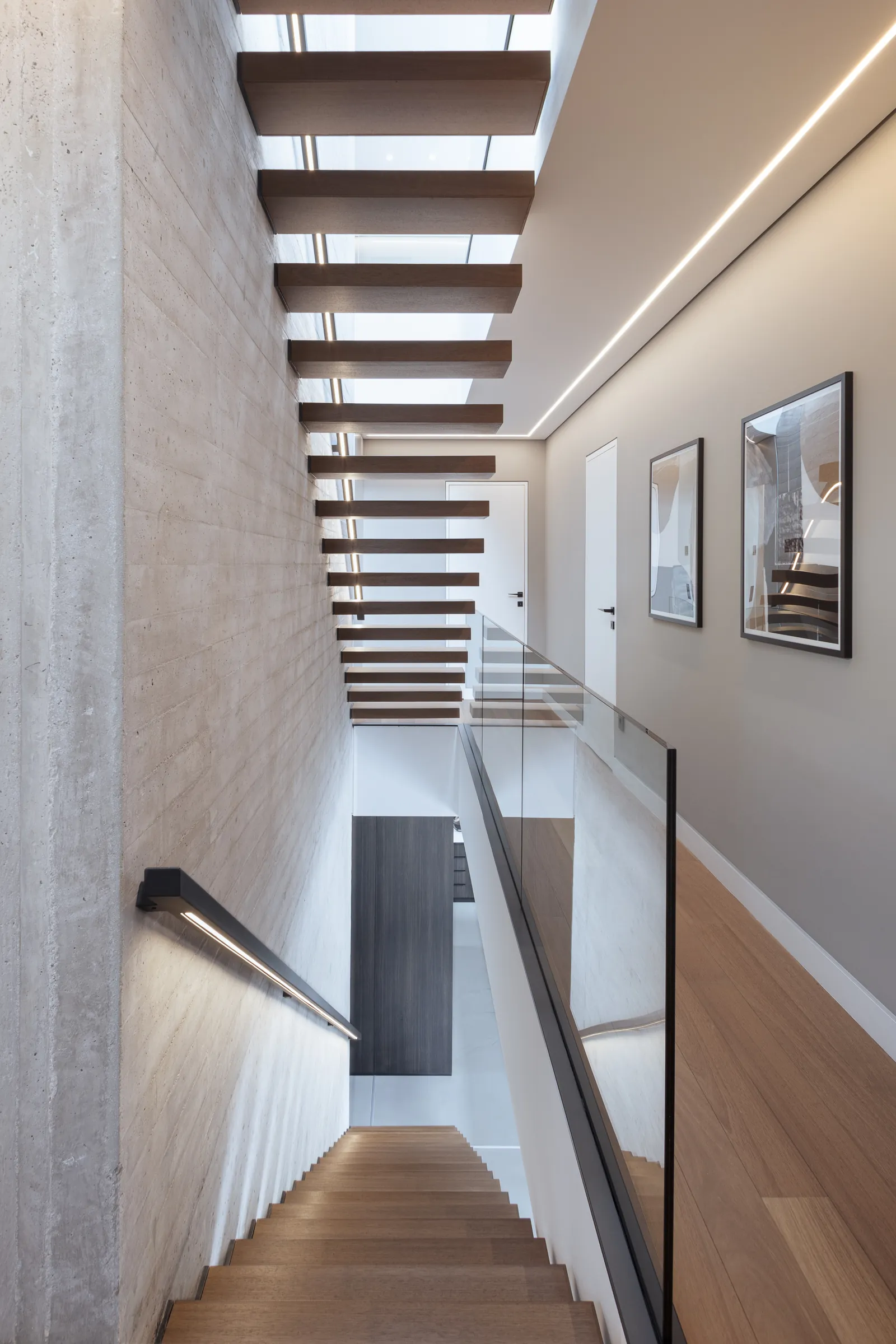 Looking down the floating staircase from the upper landing