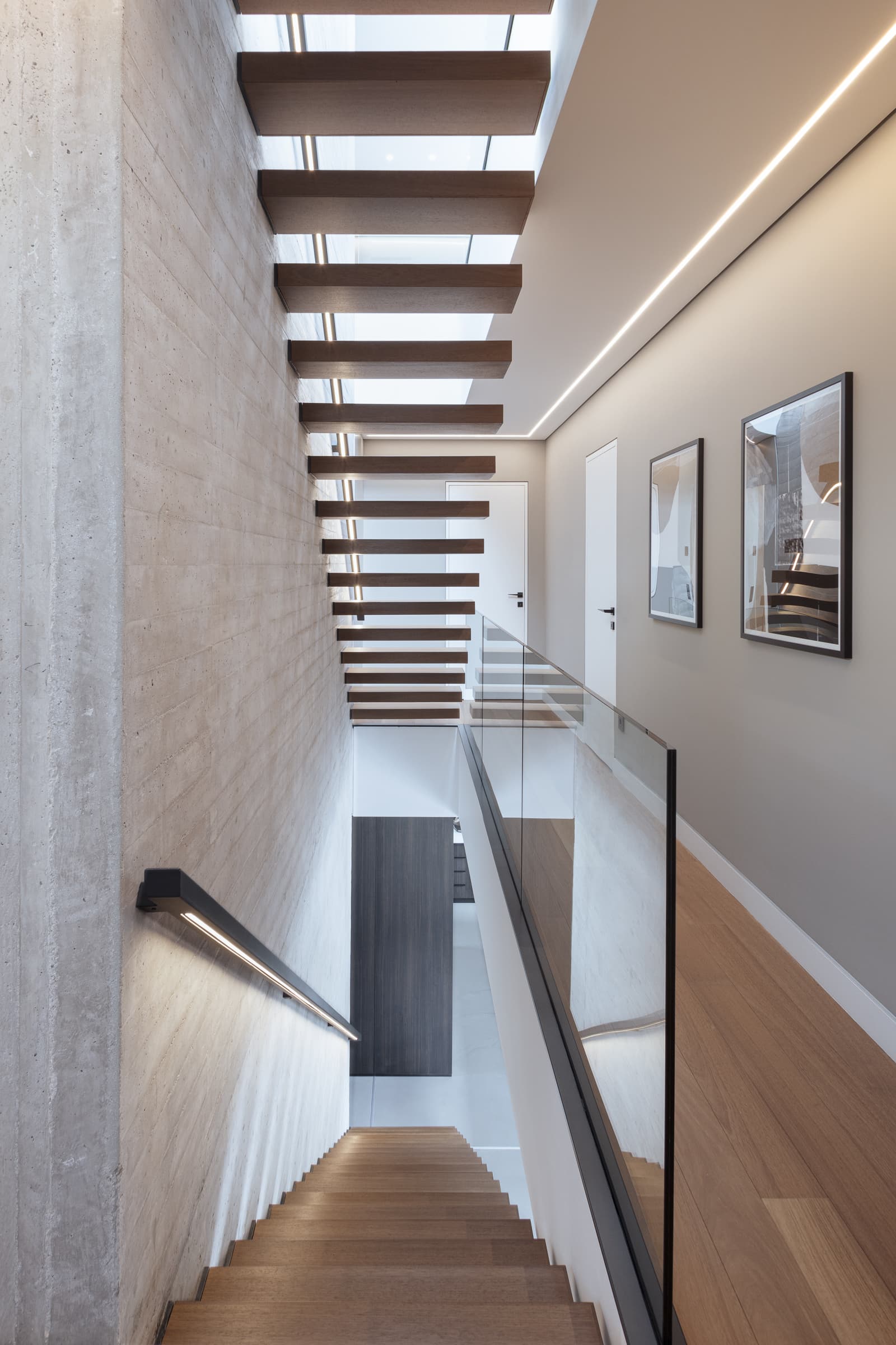 Looking down the floating staircase from the upper landing