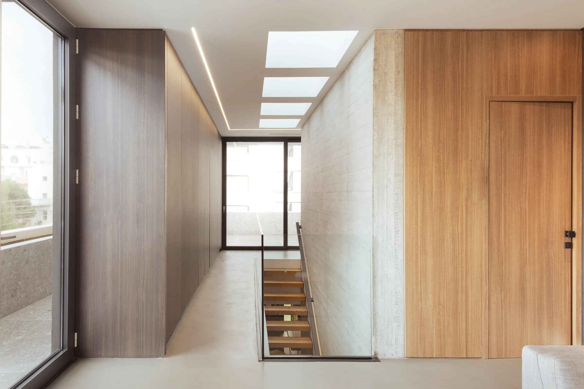 Upper-floor hallway lit by skylights