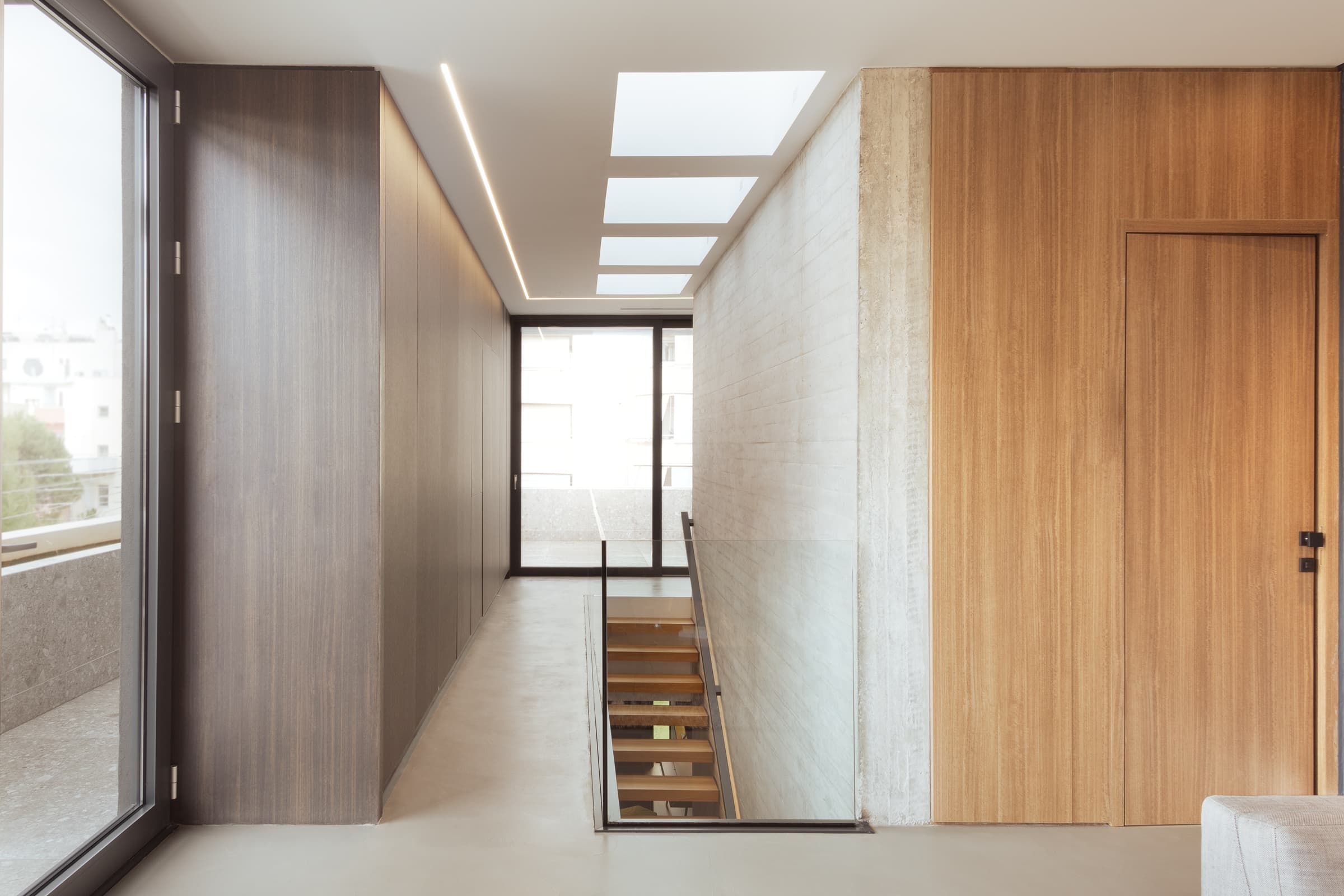 Upper-floor hallway lit by skylights